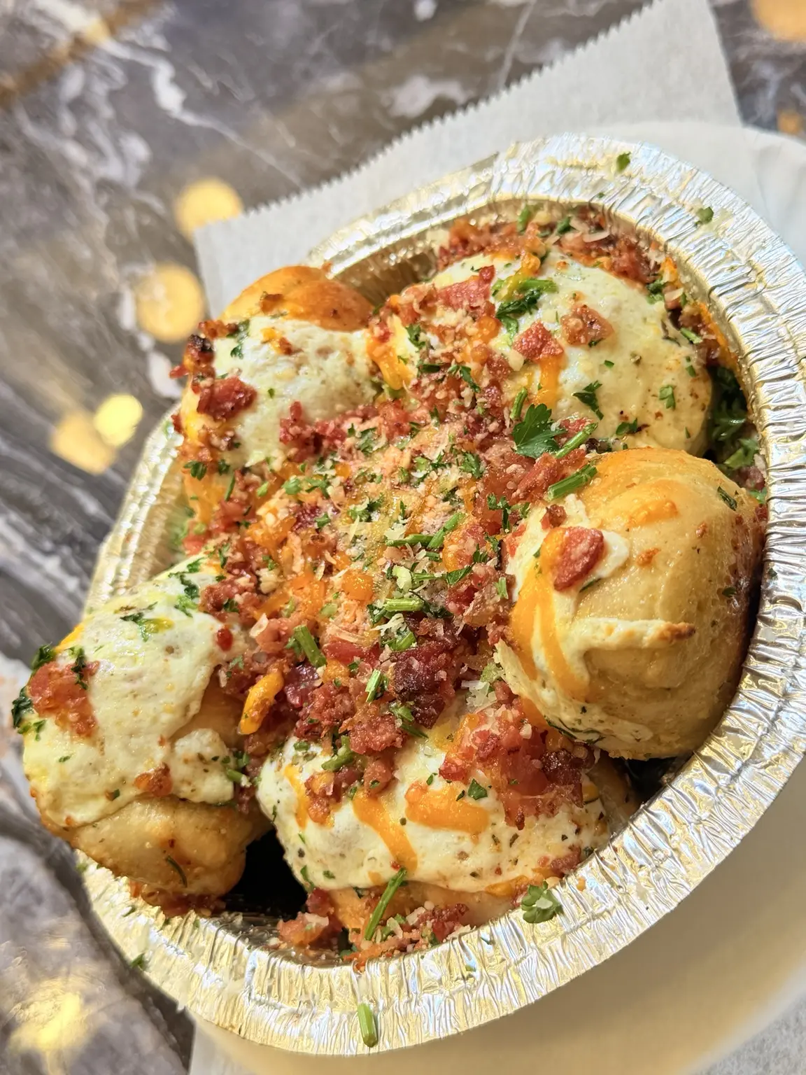 Loaded garlic knots with cheese, herbs, and bacon