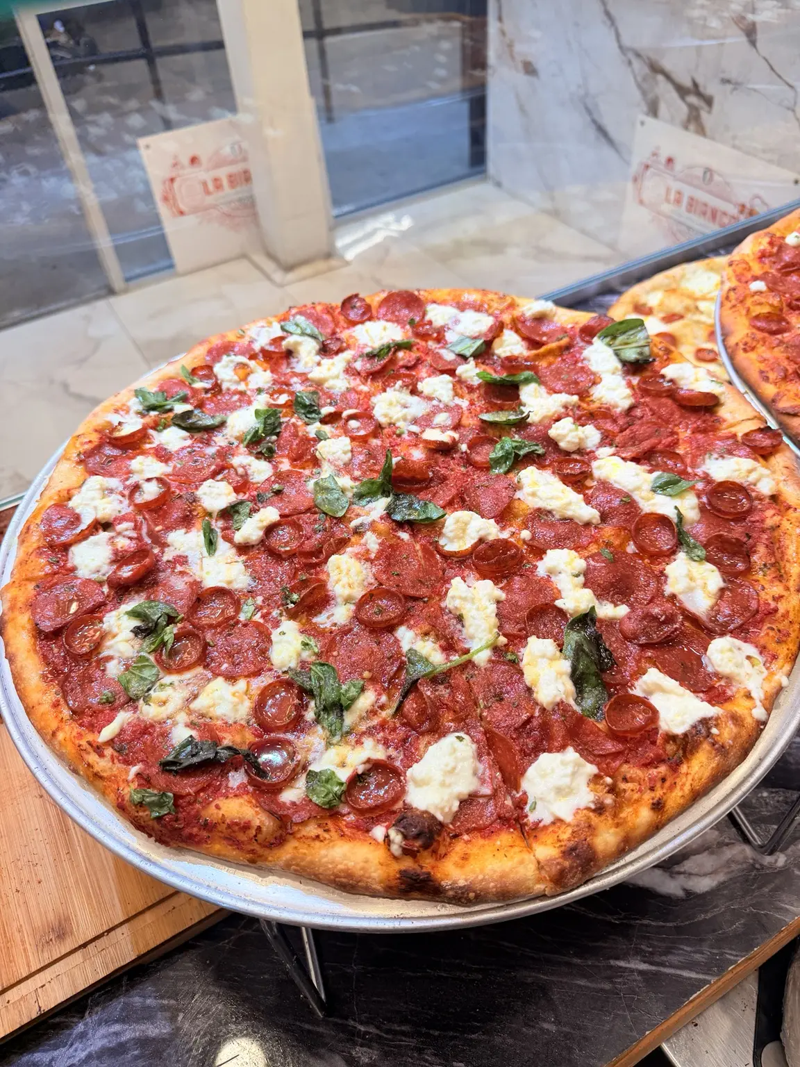 Close view of unlimited pepperoni pizza with creamy burrata
