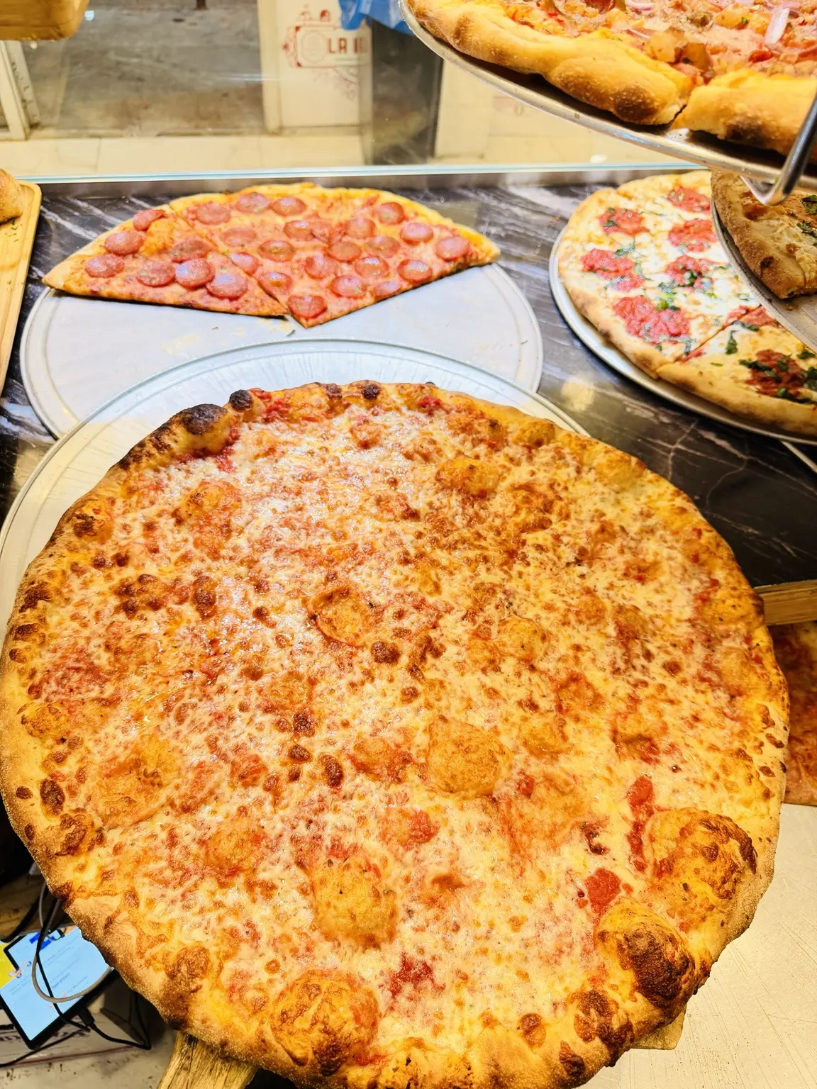 Classic New York cheese pizza at the La Bianca counter