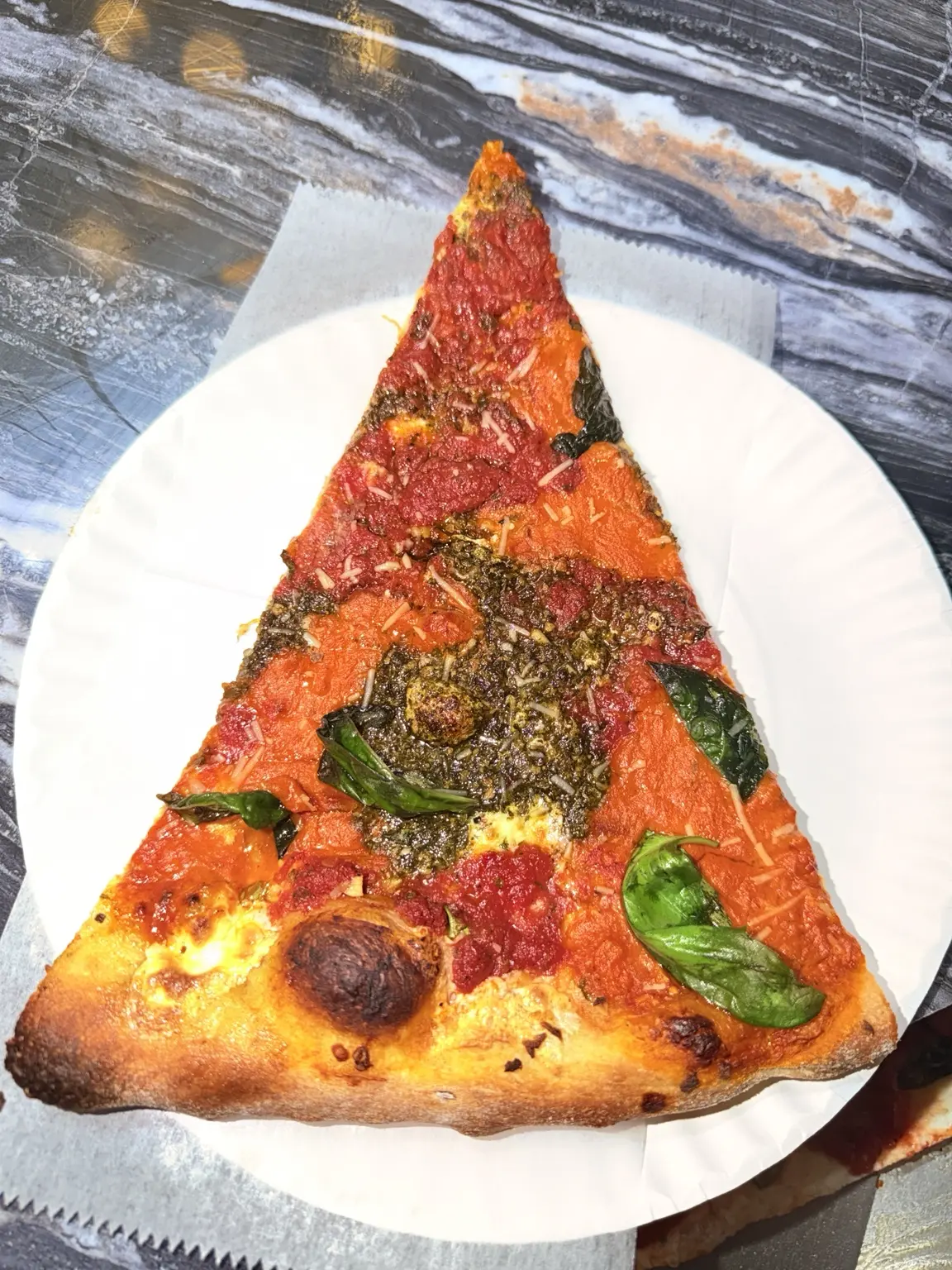A colorful house specialty slice from La Bianca Pizza
