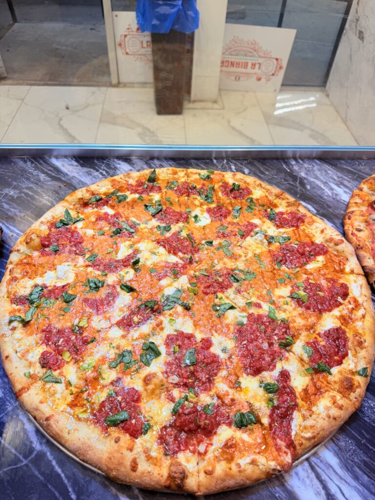 Whole Margherita pizza with tomato, mozzarella, and basil at La Bianca Pizza