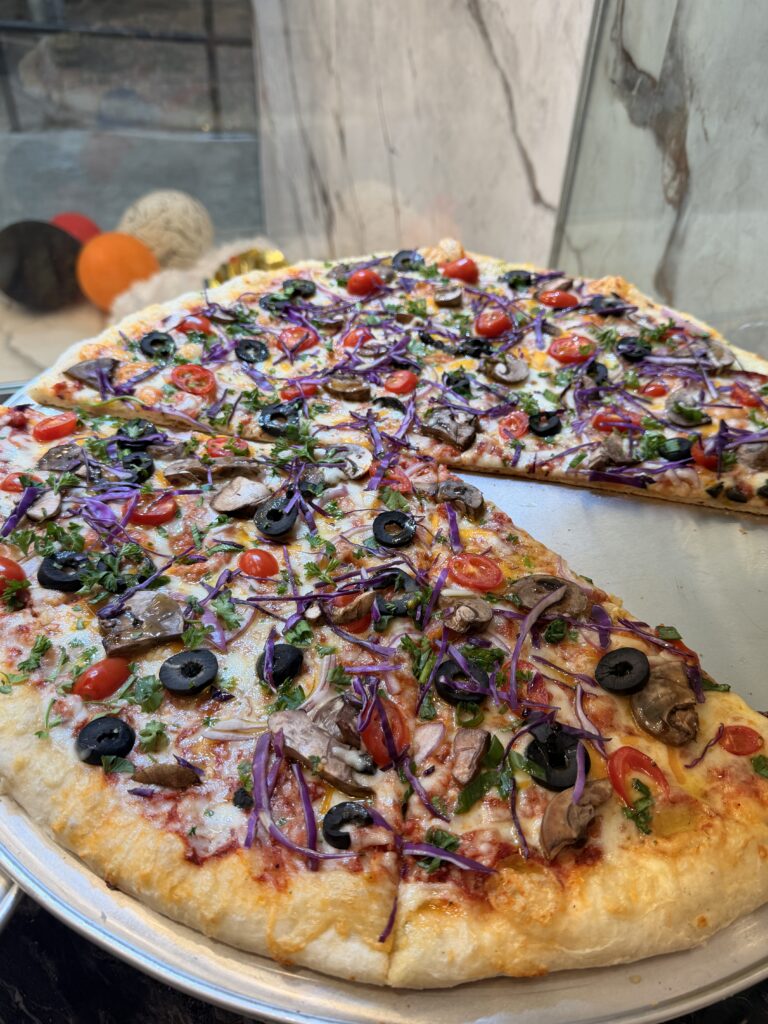 Vegetable pizza with mushrooms, olives, tomatoes, and purple cabbage at La Bianca Pizza