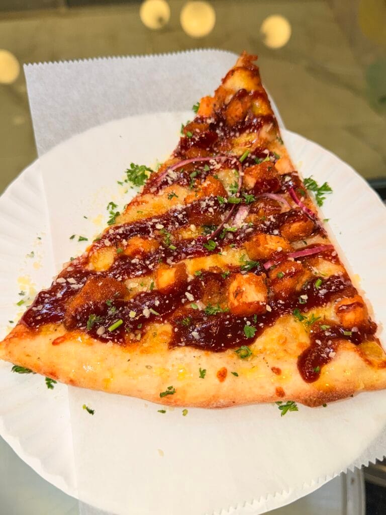 BBQ chicken pizza slice with red onion and herbs at La Bianca Pizza on West 14th Street
